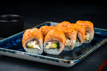 Sushi rolls with salmon tartare, smoked eel, cream cheese and avocado.