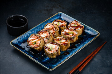 Tempura sushi rolls with shrimp, cream cheese, avocado, sesame and teriyaki sauce.