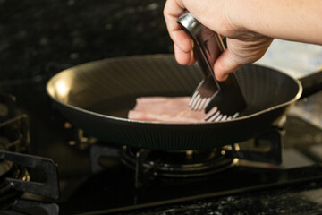 woman preparing hot cheese sandwich on morning breakfast