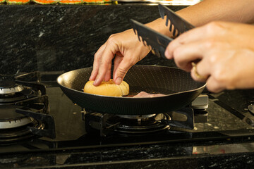 woman preparing hot cheese sandwich on morning breakfast