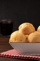 Cheese bread (pão de queijo) isolated on black background. Selective focus.