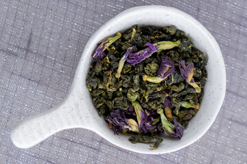 Green tea with flowers in a white bowl