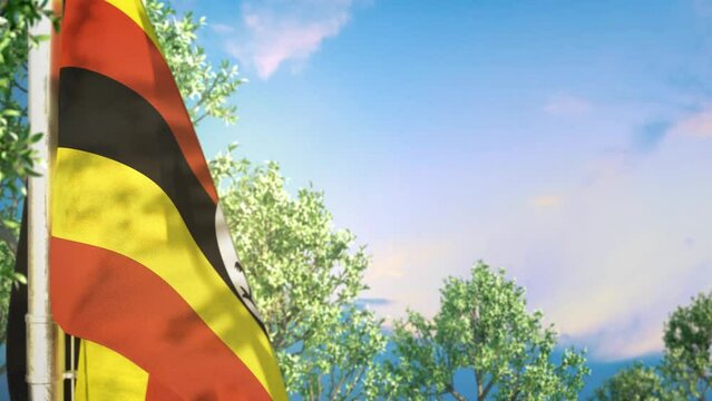 Waving flag of Uganda on forest and blue sky backdrop