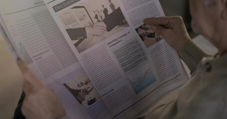 Old man reading the newspaper at home - Powered by Adobe