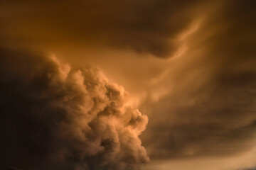 Glowing large supercell thunderheads form over the northern plains, seems almost Biblical in nature; Alberta, Canada