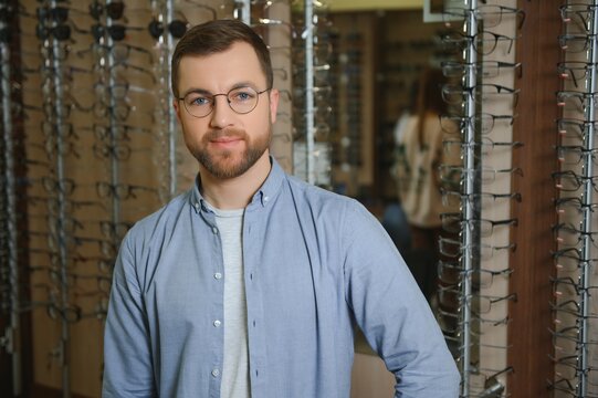 Satisfied Customer. Over The Shoulder View Of Happy Young Male Client Wearing New Glasses.