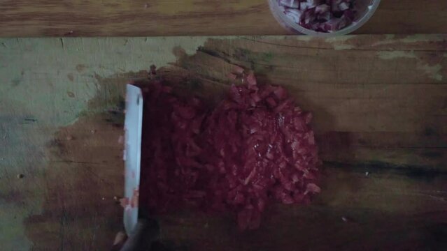 chef rushing sliced potatoes into smaller pieces