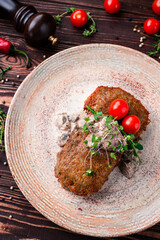 Belarusian fried potato pancakes, draniki with meat filling, porcini mushroom sauce, cherry tomatoes and microgreens.