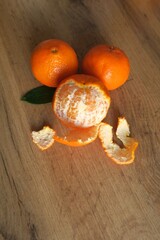 Tangerines next to cones on a wooden table