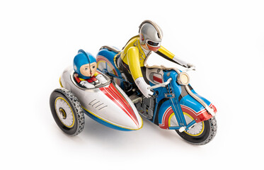 Vintage tin toy motorbike with sidecar rider isolated on white background