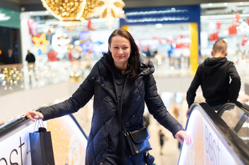 Woman on Shopping Mall Escalator