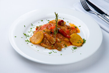 chicken in teriyaki sauce with vegetables on white plate