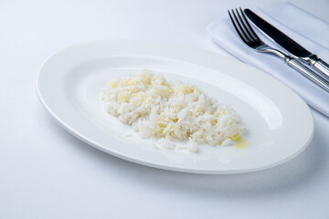 boiled rice on a white plate on white table