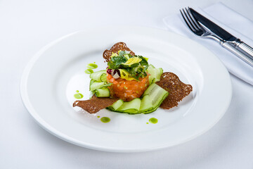 salmon Tartar on a plate on white plate
