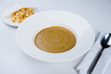 Cream soup of mushrooms on white plate