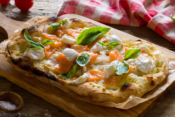 Pizza with salmon and cheese with basil on Roman dough, pinsa - 554980171
