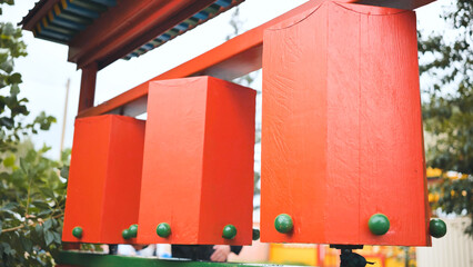 Rotation of the red prayer drums outside the Buddhist temple.
