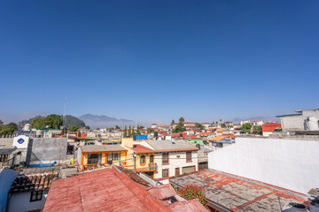 Naklejka premium Beautiful sunny day in mountain city in Mexico. The famous tiled roofs of the city.