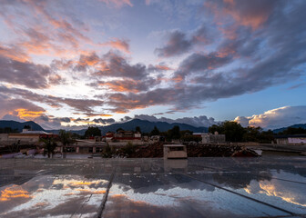 Beautiful sunset in mountain city in Mexico. The famous tiled roofs of the city.