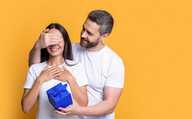 couple with surprise present, copy space. holiday couple with surprise present box.
