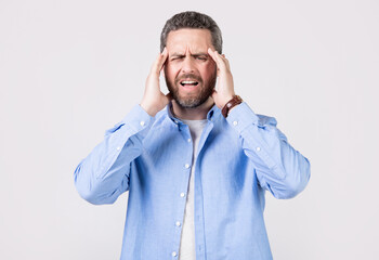 man with headache or migraine isolated on grey background. mature man with headache