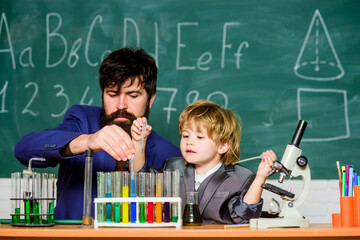 Chemistry and physics biology. bearded man teacher with little boy. father and son at school. Back...