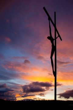 christ's body on the cross at dawn. backlight. vertical image. selective focus. copy space.