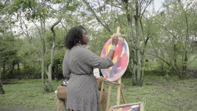 woman using her palette while painting