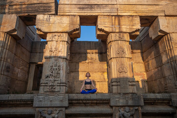 Yogini near an ancient Greek Indian temple. Mindful yoga practice. Namaste. Sun Salutation.