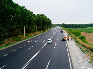 Fototapeta premium Aerial view asphalt road and green forest, Forest road going through forest with car adventure view from above, Ecosystem and ecology healthy environment concepts and background.