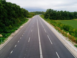 Aerial view asphalt road and green forest, Forest road going through forest with car adventure view from above, Ecosystem and ecology healthy environment concepts and background.