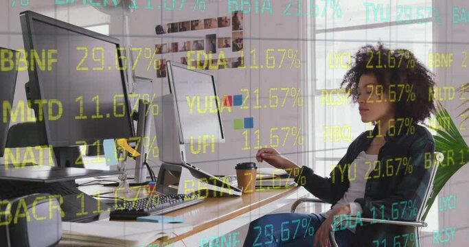 Animation of stock market data processing over biracial female graphic designer using graphic tablet