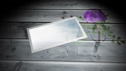 Animation of tablet with cityscape over flowers on wooden boards - Powered by Adobe