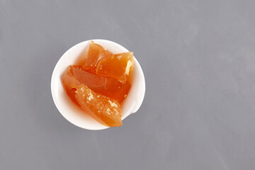 Beef bone jelly in white bowl, top view. Congealed jelly-like homemade beef bone broth with natural collagen