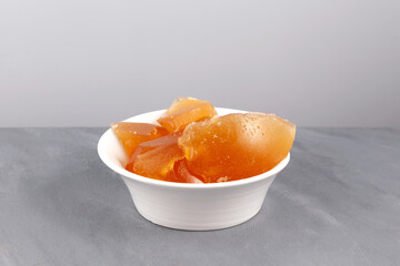 Chilled jelly-like beef broth. Jelly made from boiled beef bones in white bowl, close-up. Meat bouillon contains natural collagen for joint health - obrazy, fototapety, plakaty