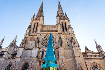 Glass Christmas tree in front of the cathedral in Bordeaux, France. Reflection of street buildings in glass. Urban winter holidays celebration background. 