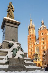 A snow-covered monument to Adam Mickiewicz on a frosty sunny winter day against the backdrop of the...