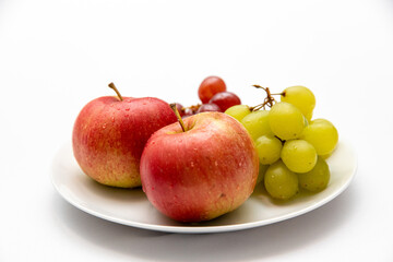Naklejka na ściany i meble Close up of apples and grapes on a plate