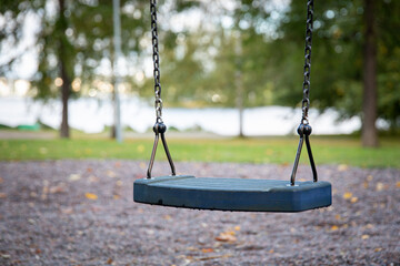 Close up of empty swing set in public park