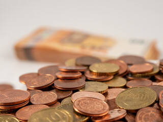 Metal coins and banknotes. A pile of euro cents and a stack of euro banknotes.