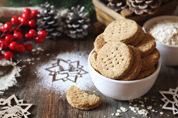 Obraz na płótnie Canvas Homemade crispy oatmeal cookies. Rustic style, new year decoration