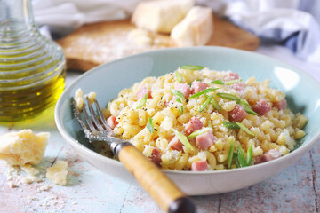 Italian Cuisine. Stortini pasta risotto  with fresh ham cubes, parmesan cheese and olive oil