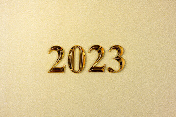 New year 2023 on golden background. Happy new year 2023 background, new year holidays card with golden sparkle. Goals, resolutions, action concept. Copy space