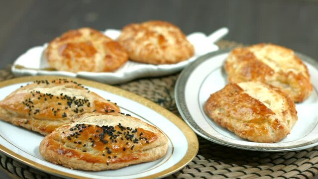 Turkish pastry product , tasty pogaca. Turkish Pastries; pogaca, borek, acma, ay coregi, Turkish bagels. ( Simit, pogaca and acma ), Homemade turkish piesl pogaca with sesame seeds at patisserie showc