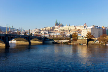 Obraz premium Snowy Prague Lesser Town with Prague Castle above River Vltava in the sunny Day , Czech republic