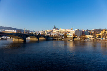 Snowy Prague Lesser Town with Prague Castle above River Vltava in the sunny Day , Czech republic