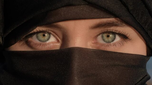 Beautiful Muslim Woman in Hijab Open Her Green Eyes Looking at Camera, Dramatic Close Up