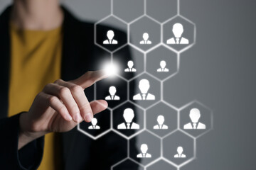 Human resources manager pointing at virtual network chain with person icons. Human capital and teambuilding concept.