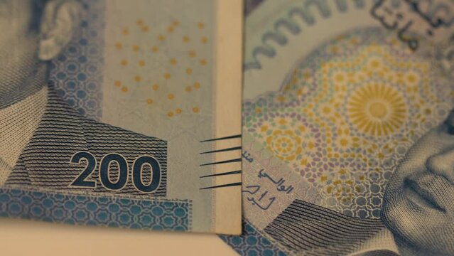 Moroccan money texture. 200 Dirhams bills paper. Rotative close-up