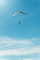 Epic paragliding flight on a beautiful sunny day. Copy space below